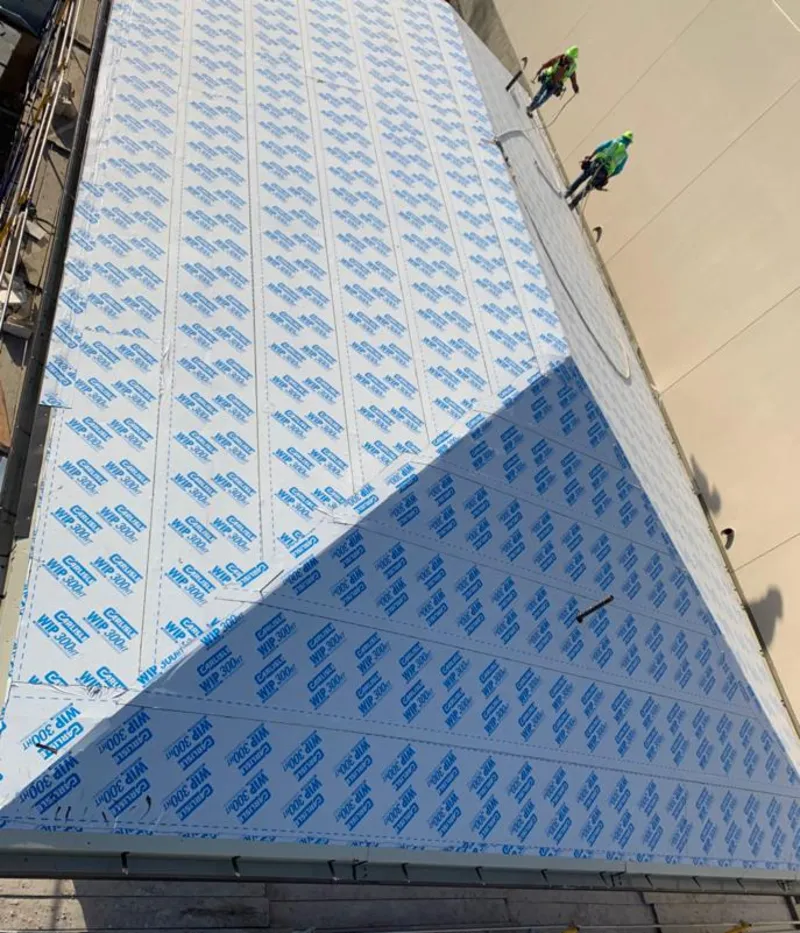 Professional roofers installing underlayment on a metal roof in Wake Village